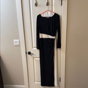 Long sleeved evening gown. Black with white waistline emphasis.